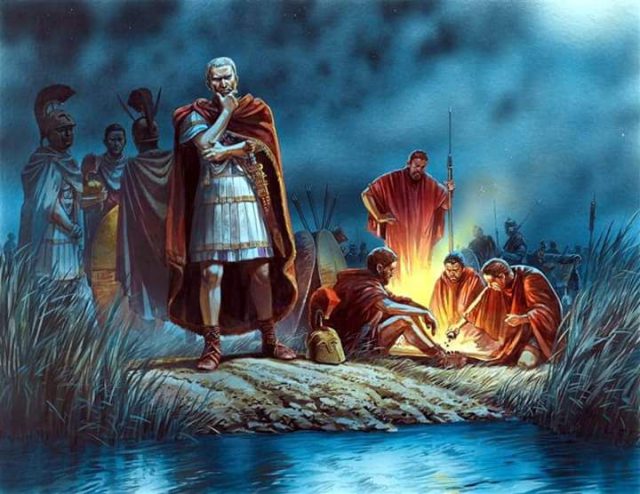 Grafika ukazująca rozmyślającego Cezara przed przekroczeniem Rubikonu