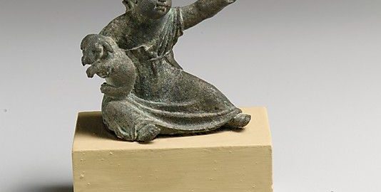 Unique antique figurine showing girl holding dog