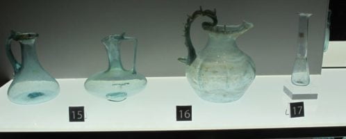 A collection of Roman glass vessels in the collection of the Museum at Castle Colchester, erected on the foundations of the Temple of Claudius