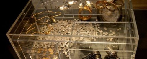 The treasure of Hoxne on display. The display case shows what the  treasure chest looks like