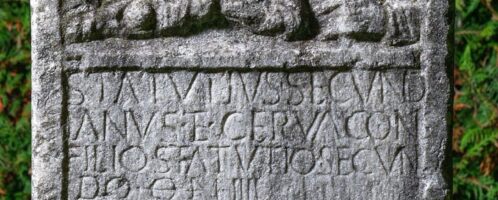 Roman tombstone showing child with his parents