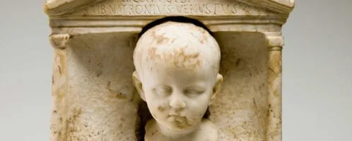 Roman tombstone with image of small child's head