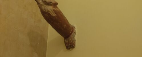 Phallus-shaped object attached to wall