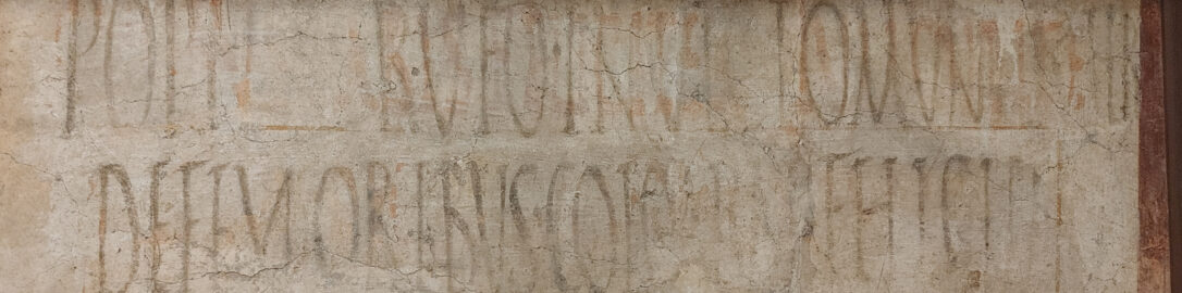 Fragment of Roman fresco with black inscriptions